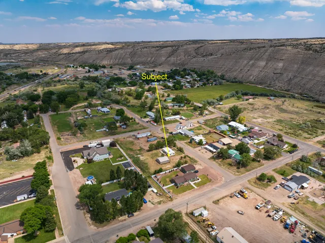 Aerial perspective showcasing the property within a residential setting