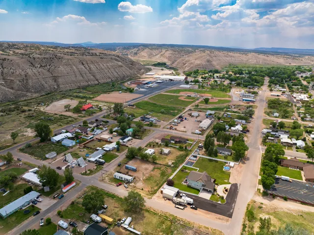 Aerial perspective showcasing a residential community against a backdrop of natural bluffs and open terrain