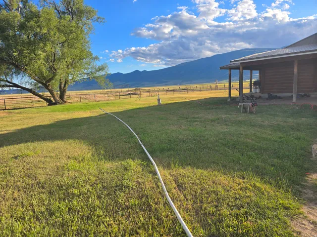 Expansive green lawn with mountain backdrop