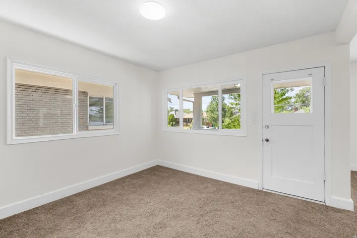 Neutral wall color with white trim and brown carpet