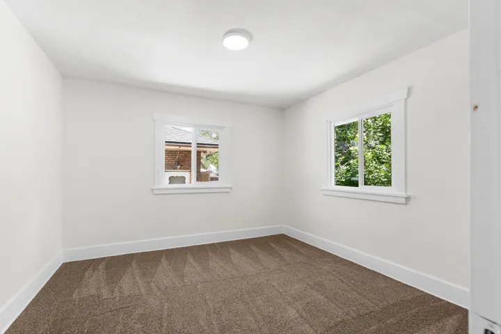 Neutral wall finishes with white baseboards and window trim