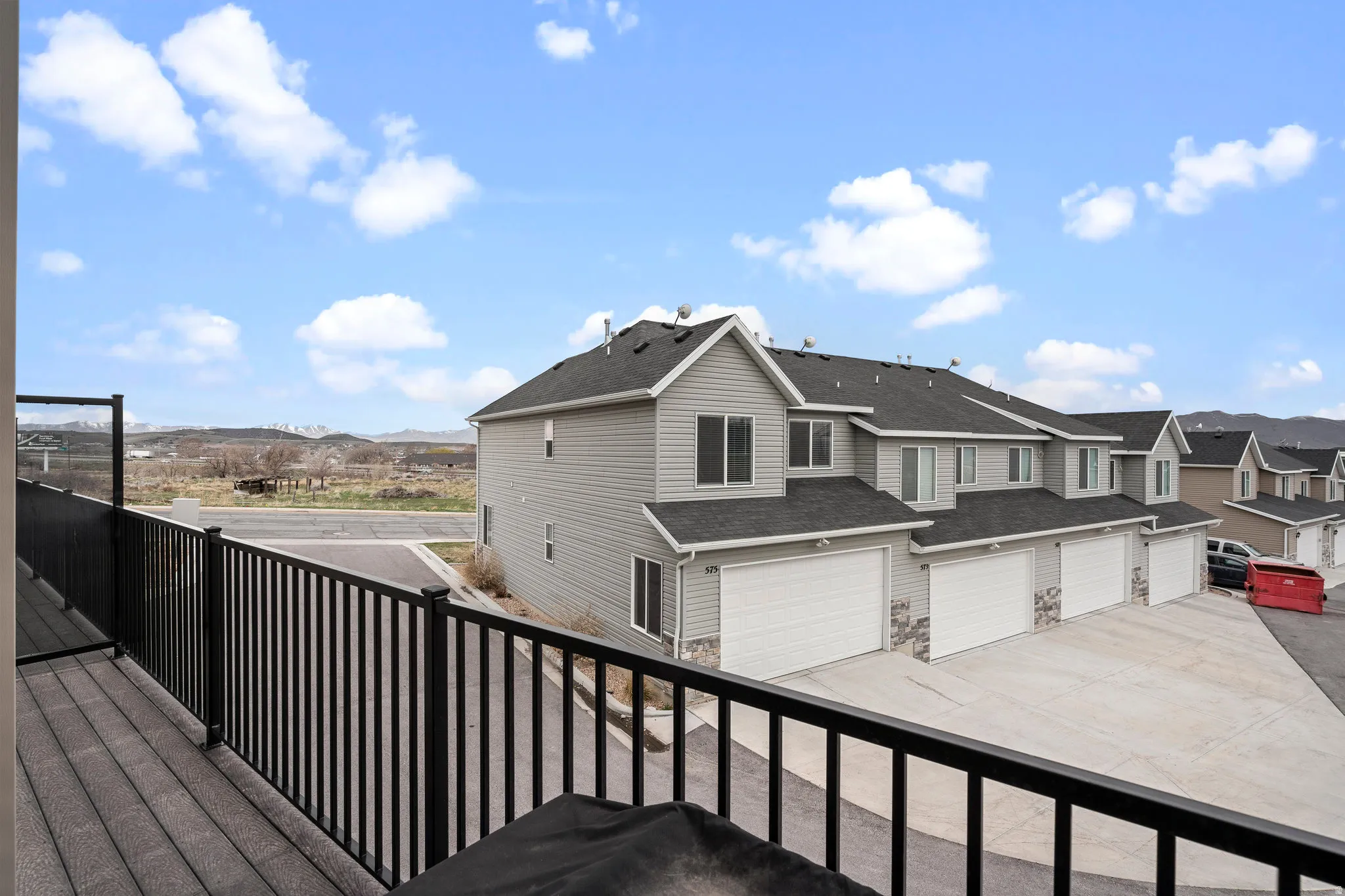Exterior balcony with black metal railings and composite decking