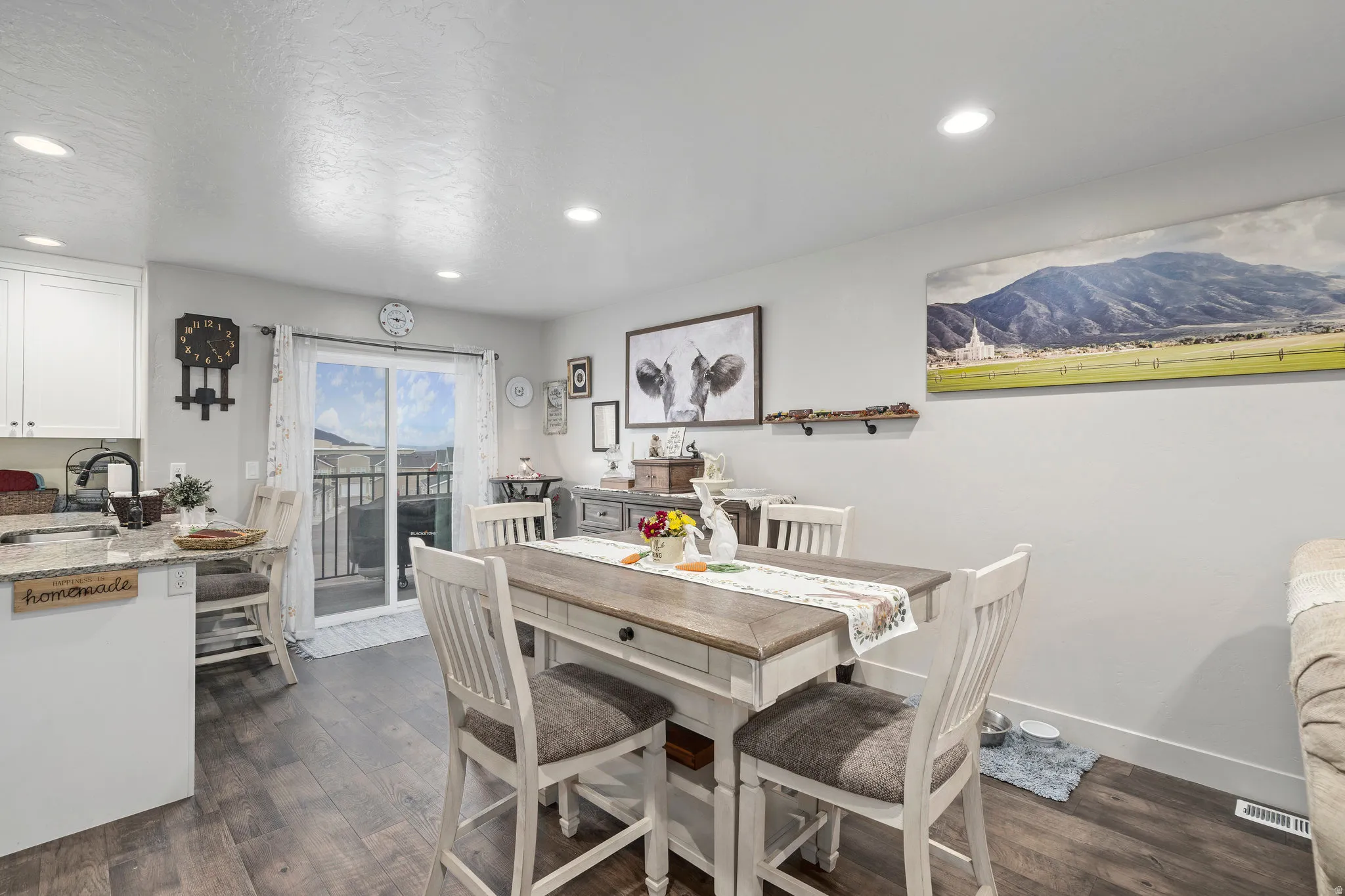 Open-concept dining and kitchen area with wood-finish flooring