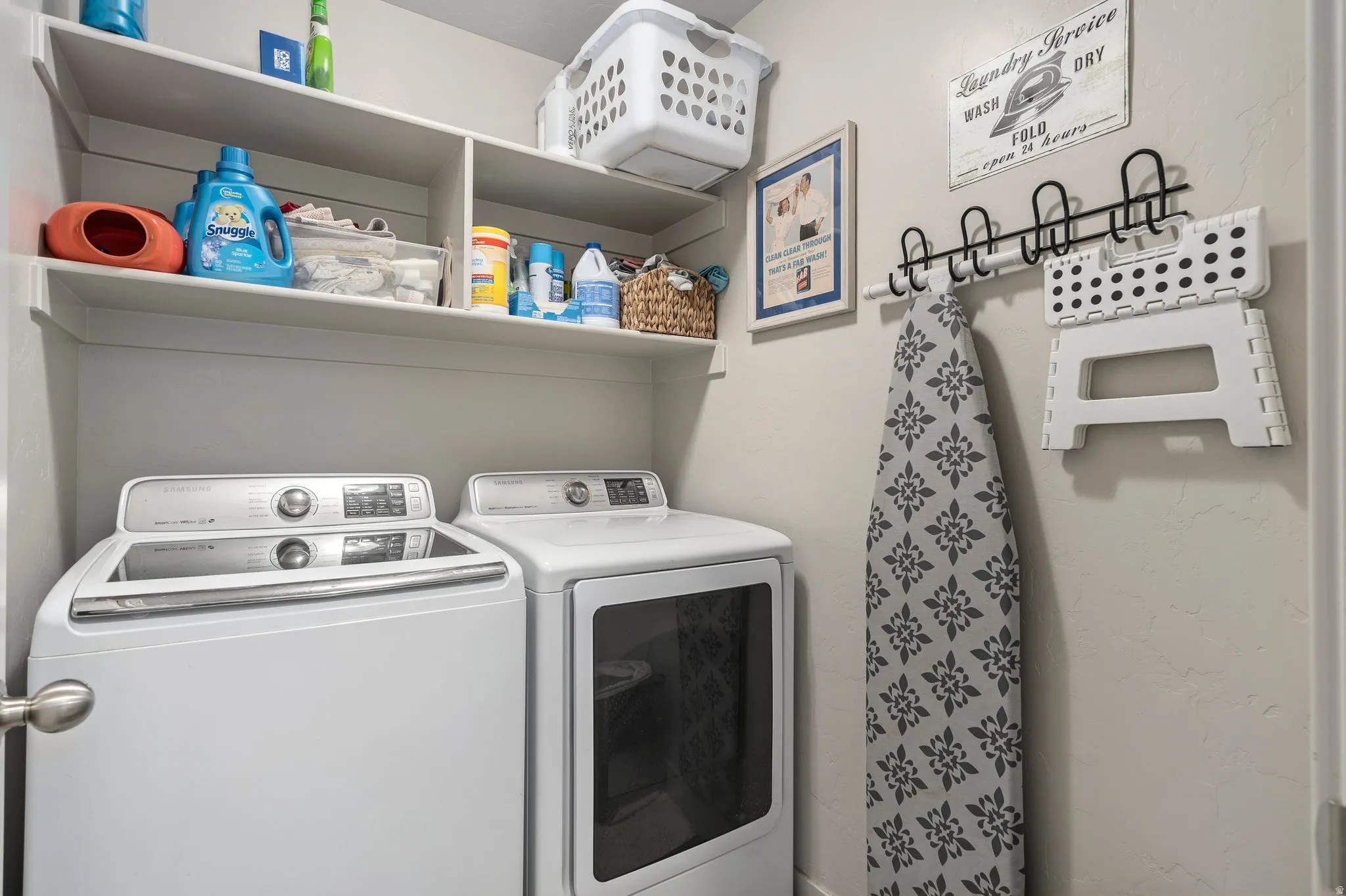 Dedicated laundry area featuring a white top-load washing machine and front-load dryer