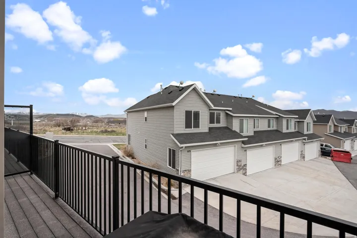 Exterior balcony with black metal railings and composite decking