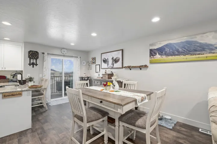 Open-concept dining and kitchen area with wood-finish flooring