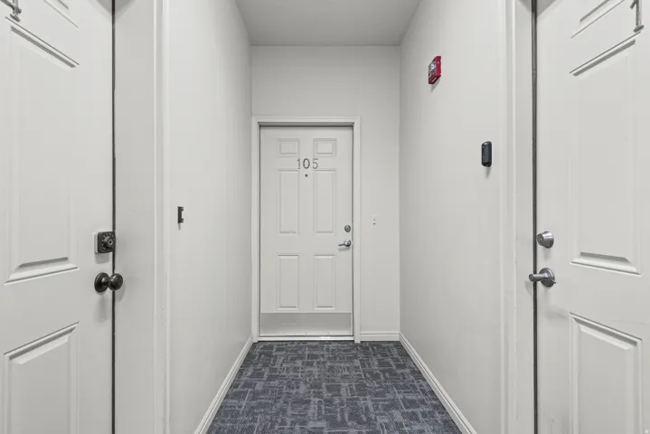 Hallway with patterned carpet flooring