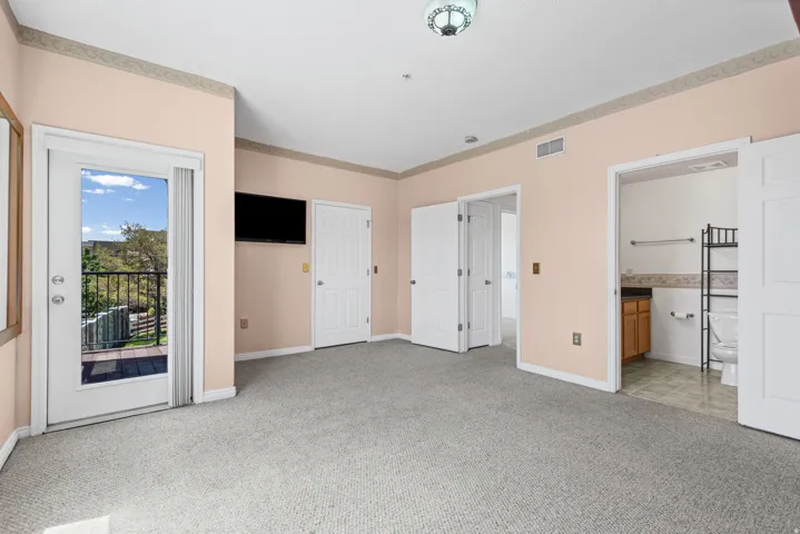 Room featuring wall-to-wall carpeting, light-colored walls, white trim, and a ceiling light fixture