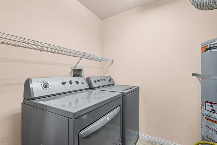 Dedicated laundry area featuring a wire shelving unit