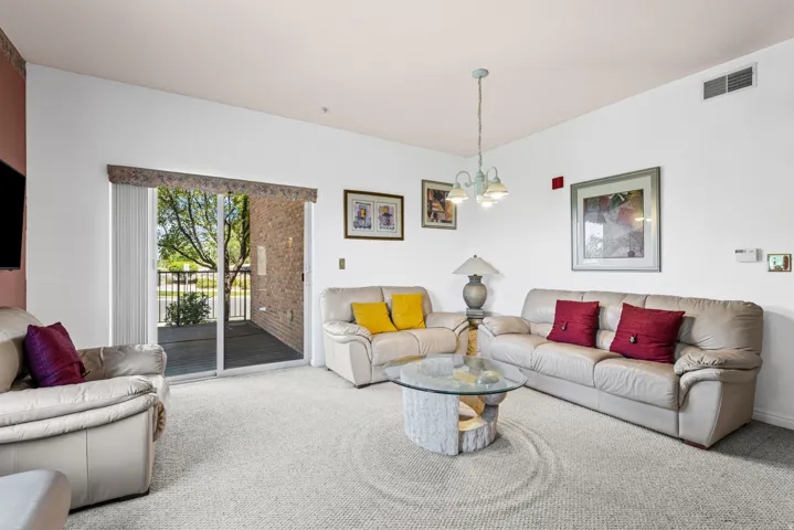 Living area with light-toned carpeting and white walls