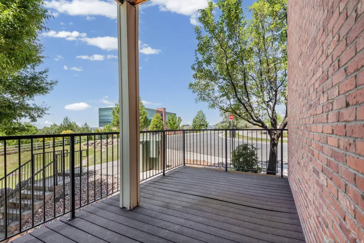 Outdoor deck with composite plank flooring and black metal railings