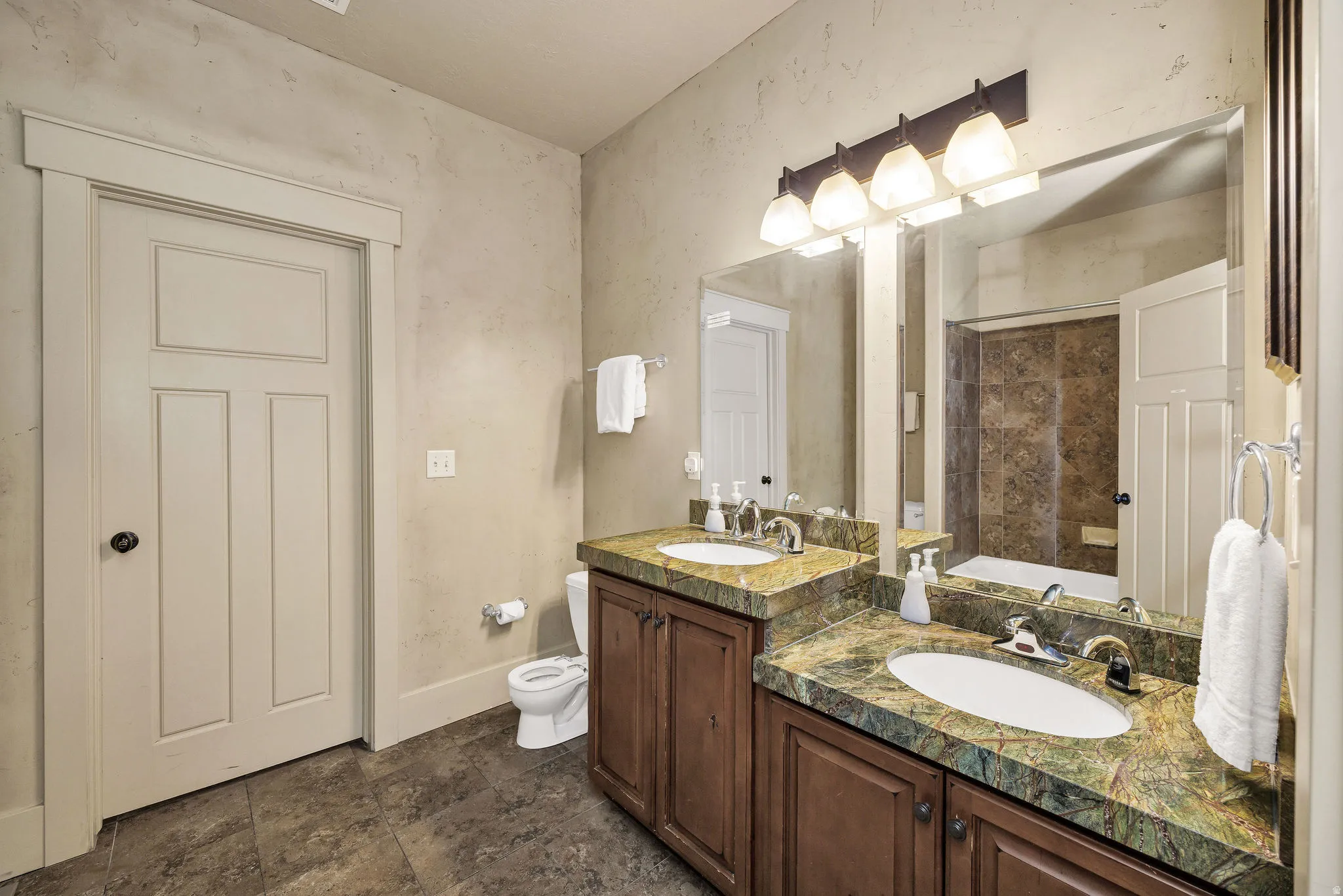 Dual undermount sinks with chrome fixtures set into a green-patterned countertop