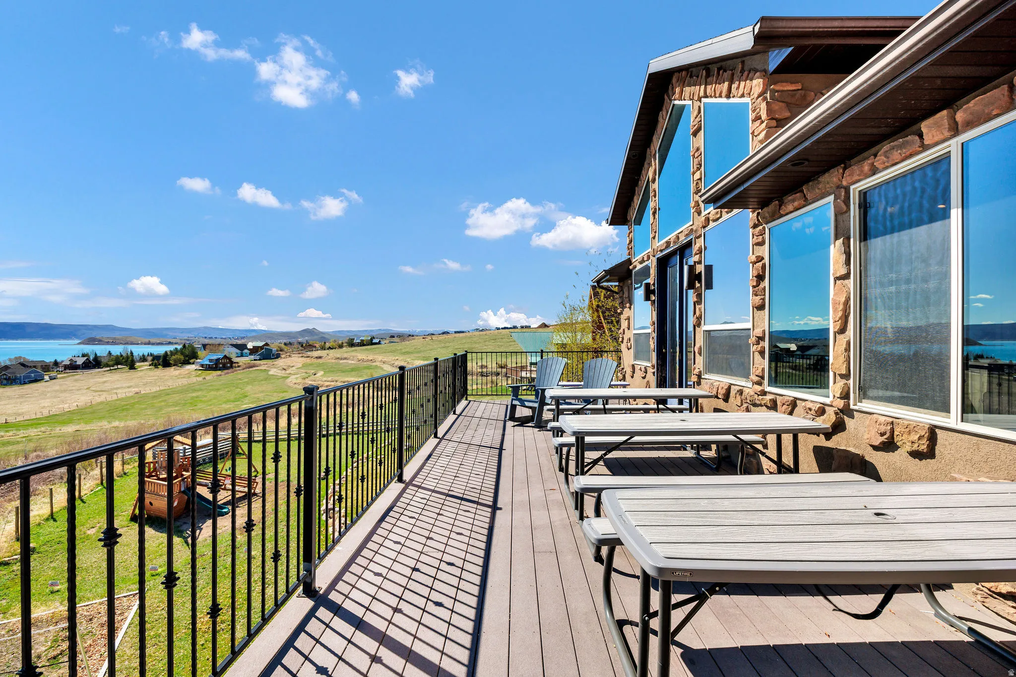 Expansive outdoor deck featuring composite decking and decorative wrought iron railing