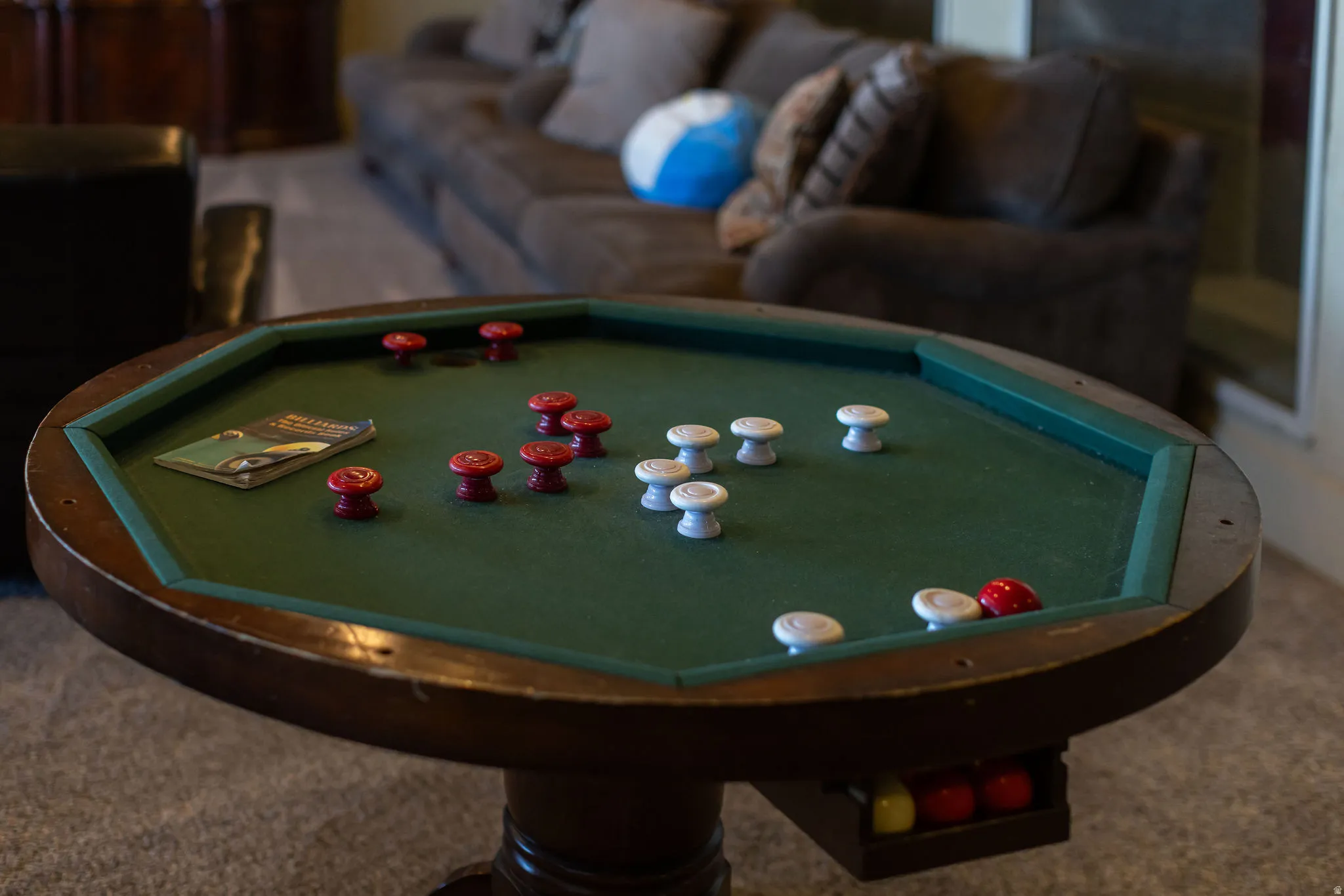 Octagonal game table featuring a green felt surface and a dark wood-finish base