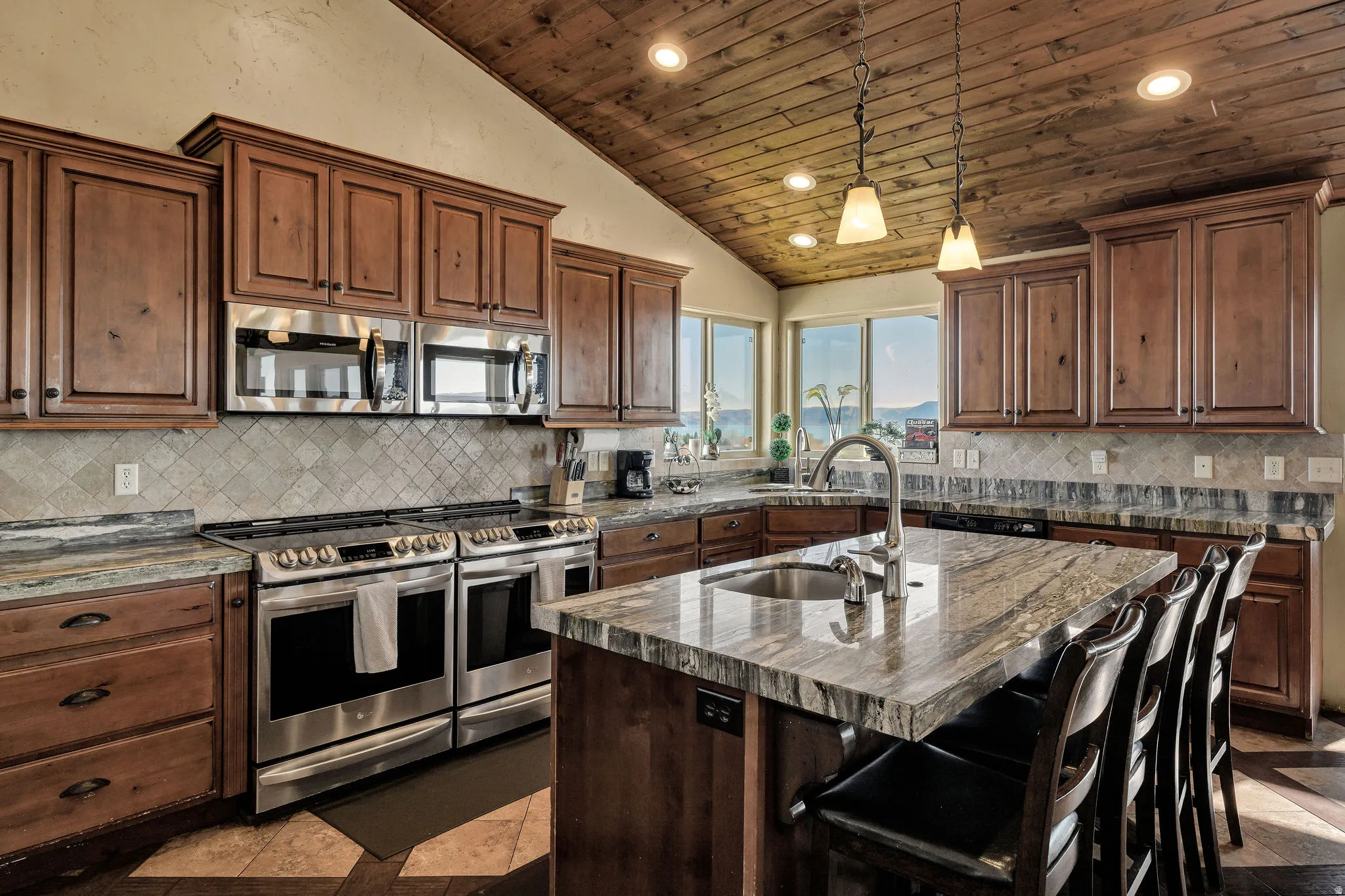 Kitchen featuring a wood-finish vaulted ceiling, recessed lighting, and pendant fixtures