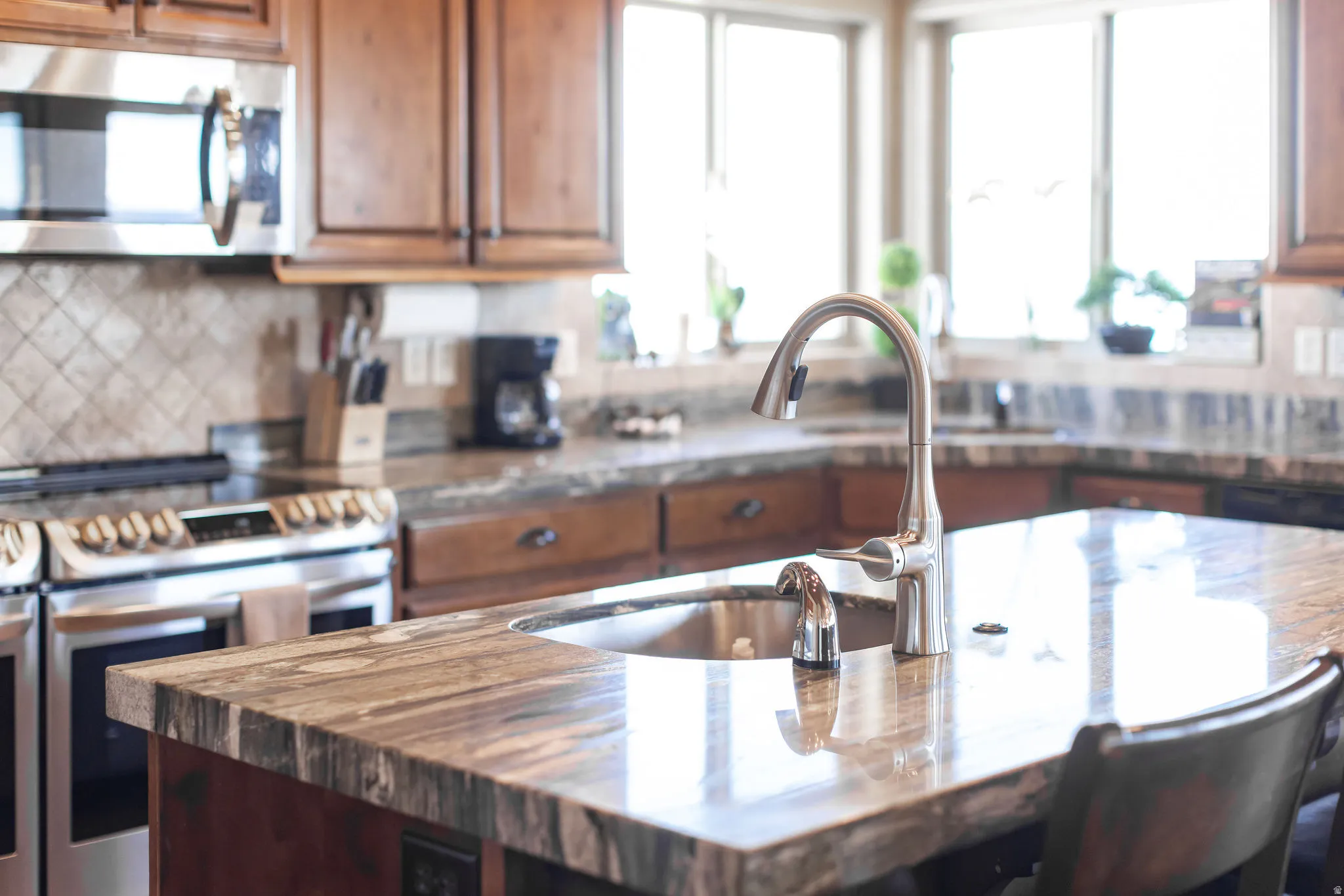 Kitchen island with an undermount sink and gooseneck faucet