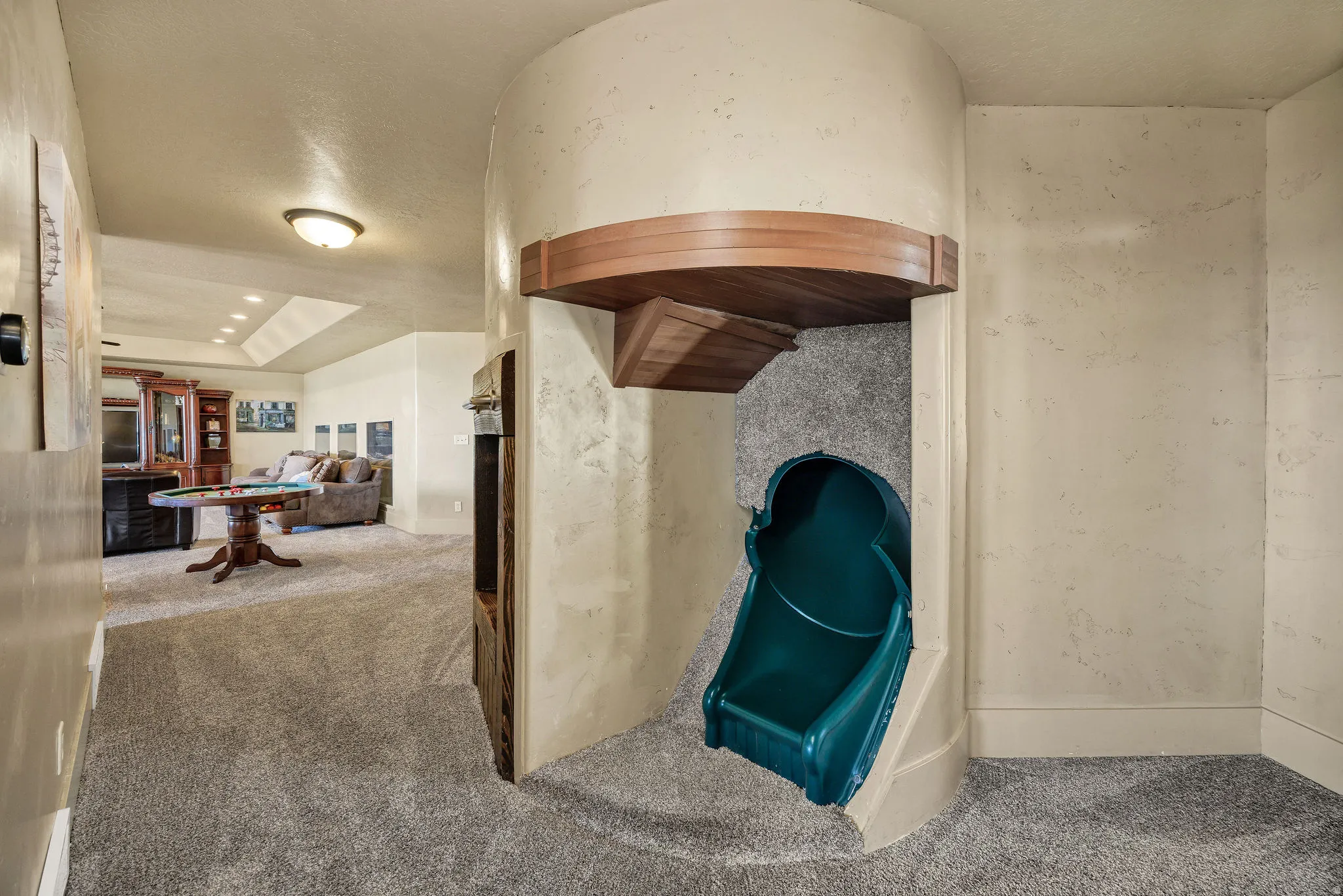 Built-in slide feature with a curved architectural wall and wood-finish trim