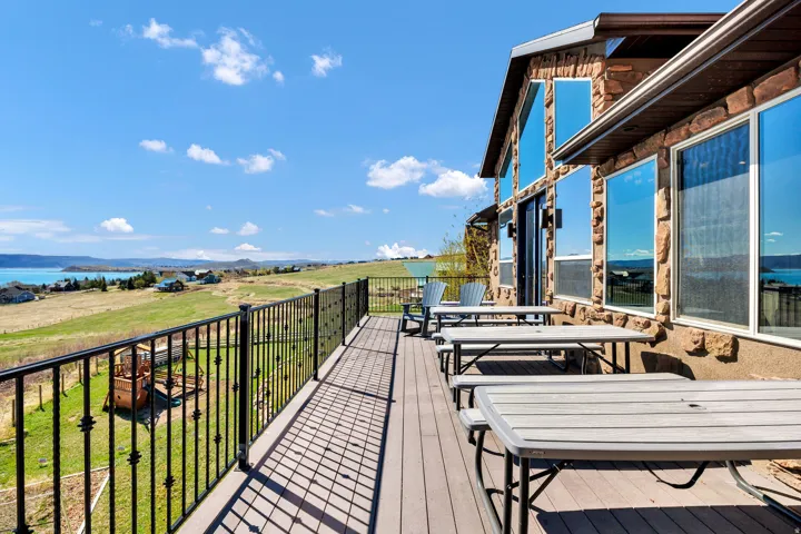 Expansive outdoor deck featuring composite decking and decorative wrought iron railing