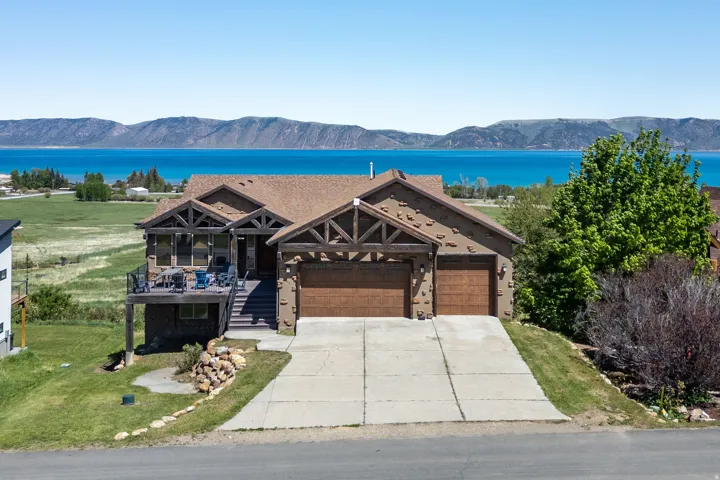 Craftsman-style residence with a two-car garage, featuring a stone and stucco exterior