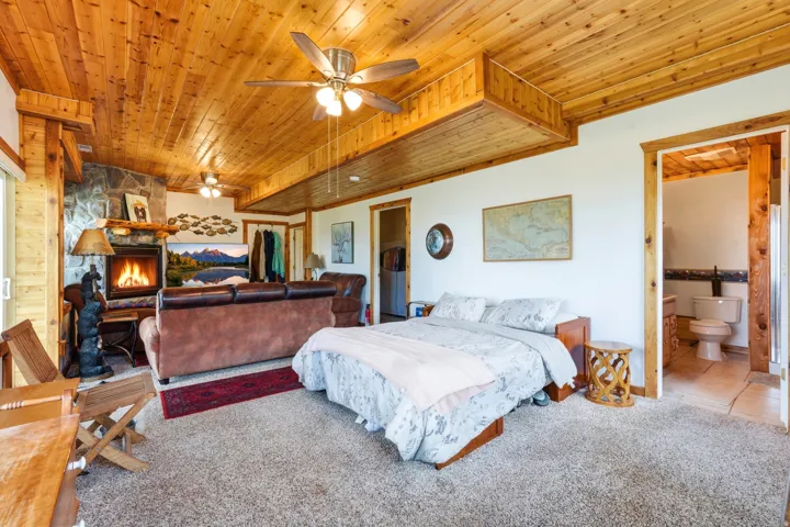 Wood-plank ceiling with exposed beams and recessed lighting