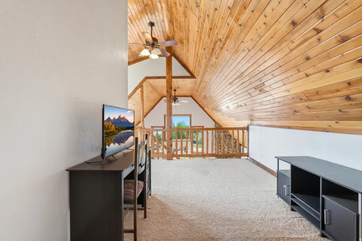 Vaulted wood-paneled ceiling with exposed beams