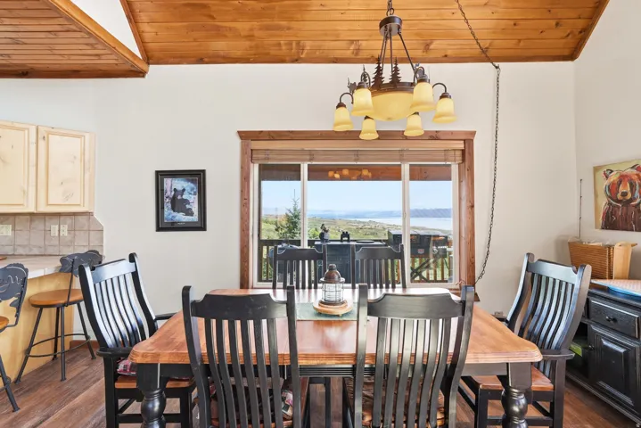 Dining area featuring a wood-finish ceiling, a multi-light chandelier, and wood-finish flooring