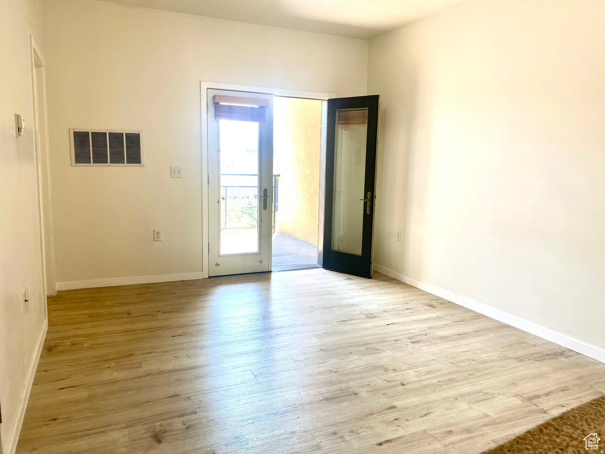 Light wood-finish flooring complements neutral wall tones