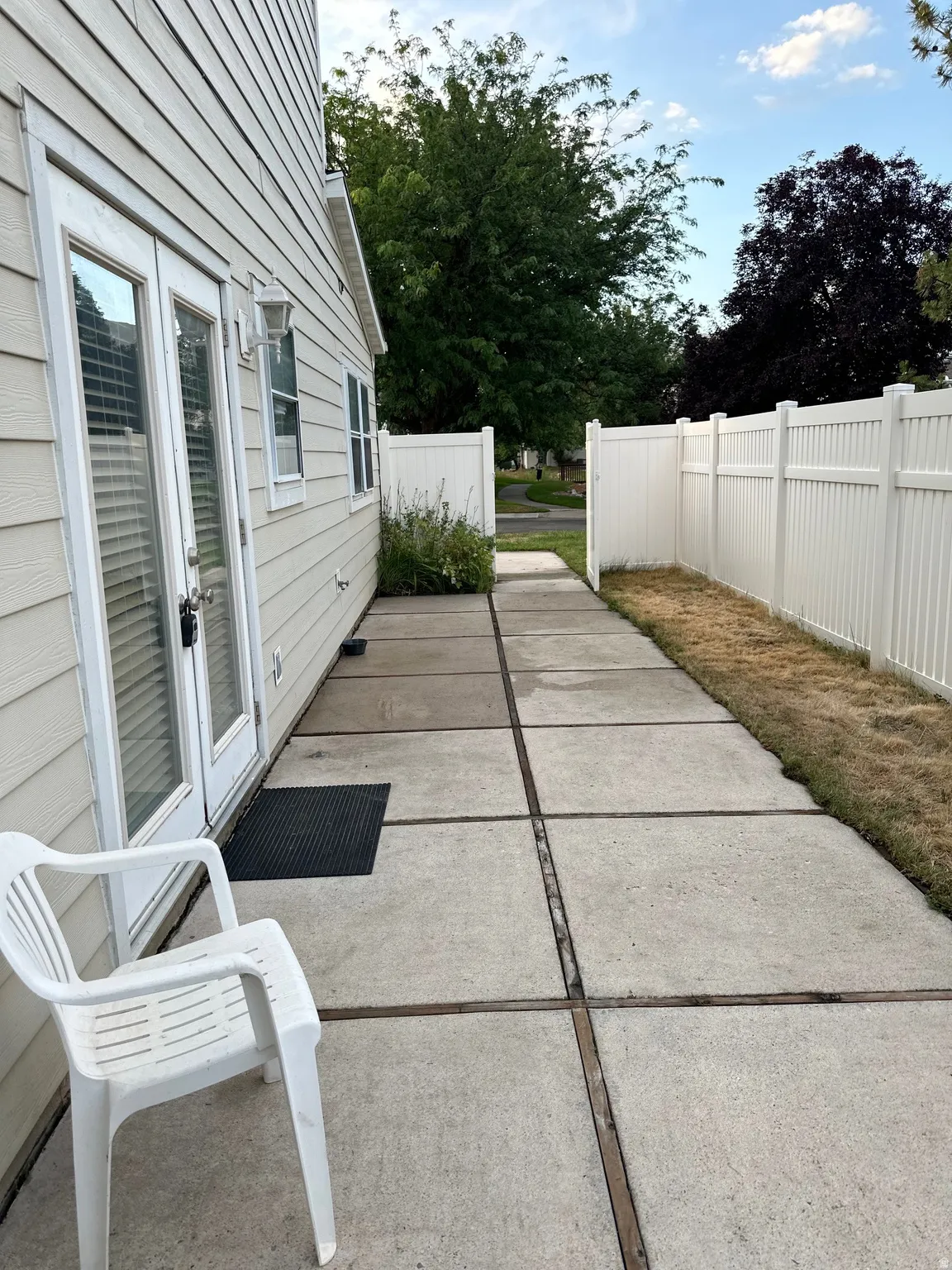 Private concrete patio accessed via double glass-paned doors