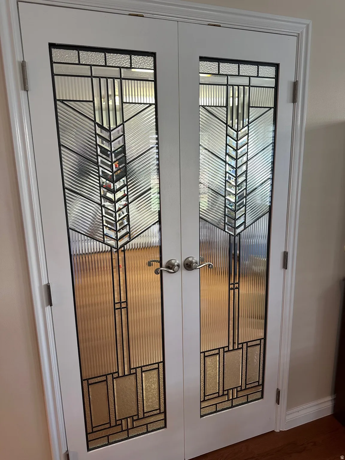 White French doors with decorative glass inserts featuring a geometric pattern
