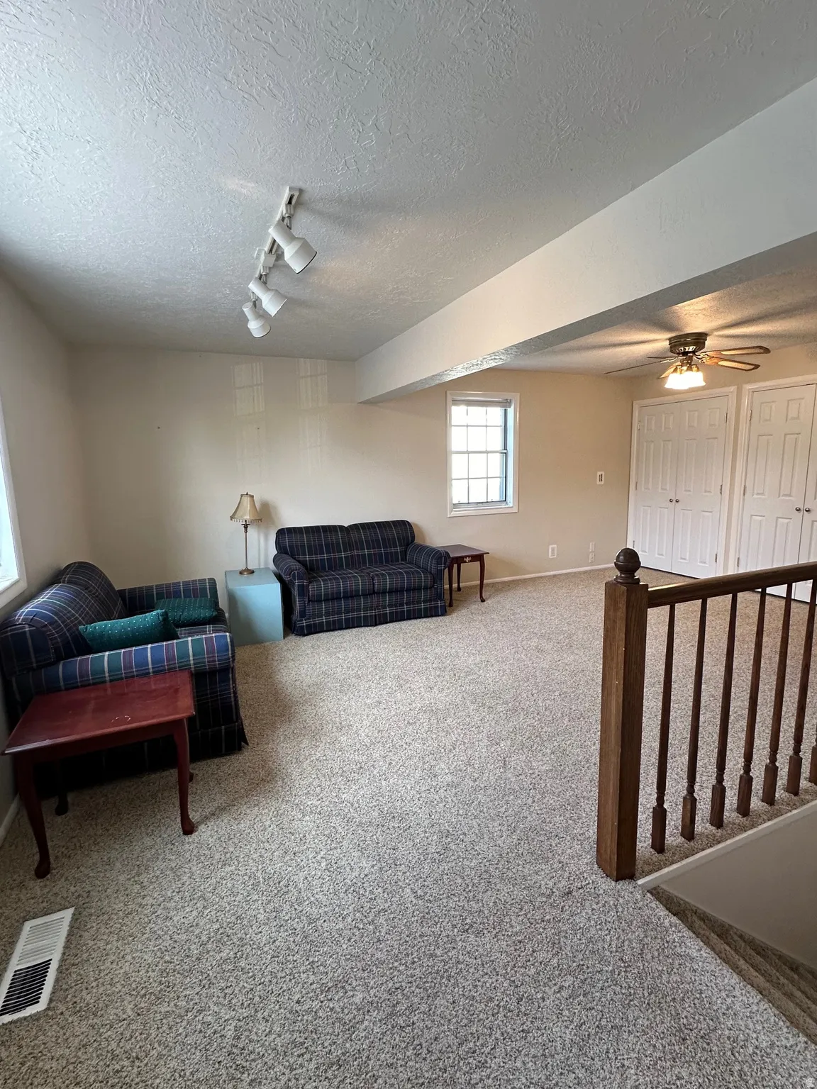 Spacious room featuring neutral carpeting and light-toned walls
