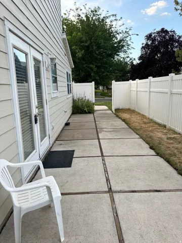 Private concrete patio accessed via double glass-paned doors.