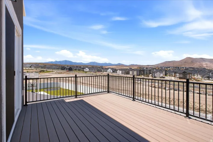 Spacious deck featuring composite decking and black metal railings