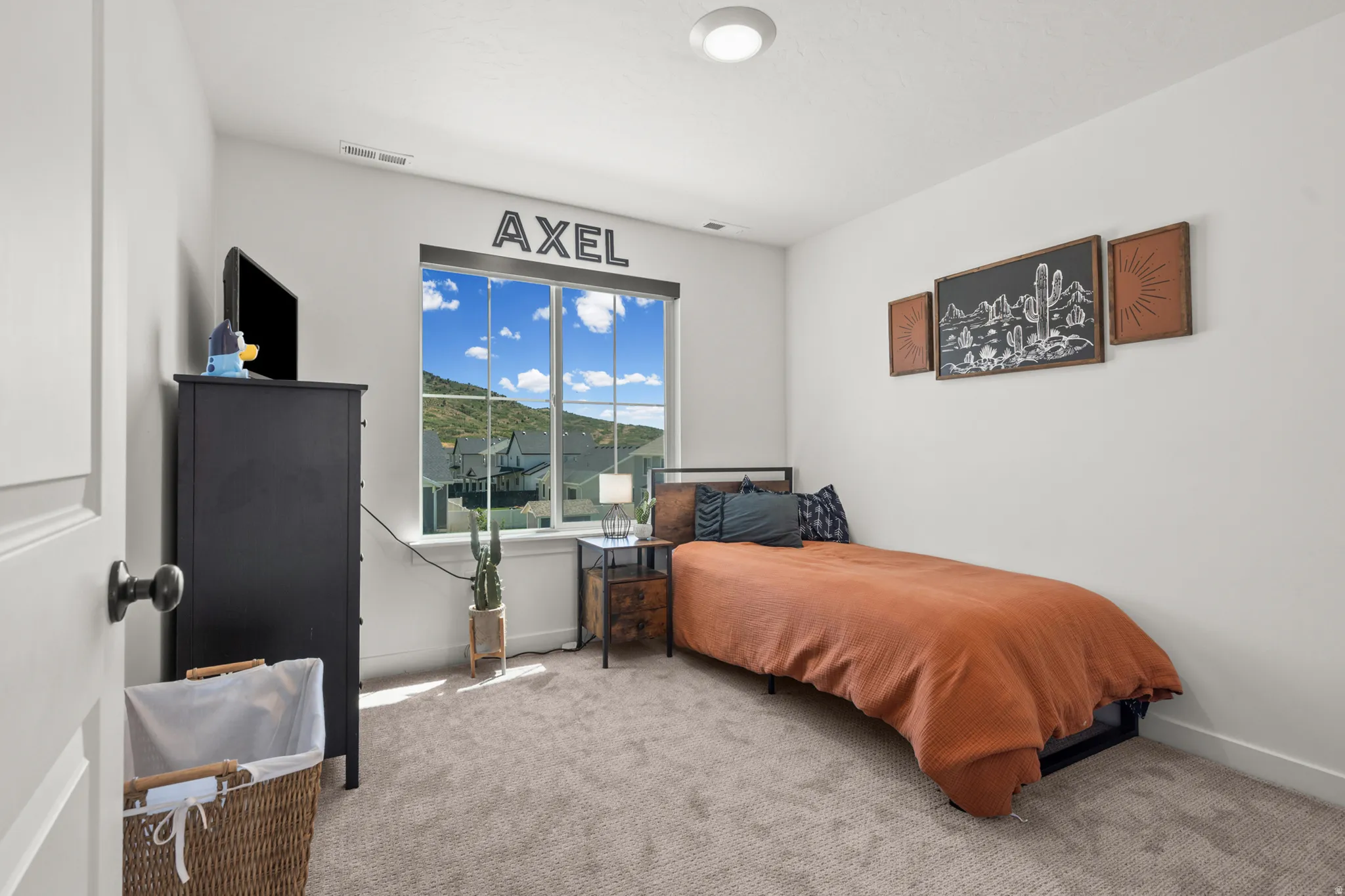 Carpeted room with a large window