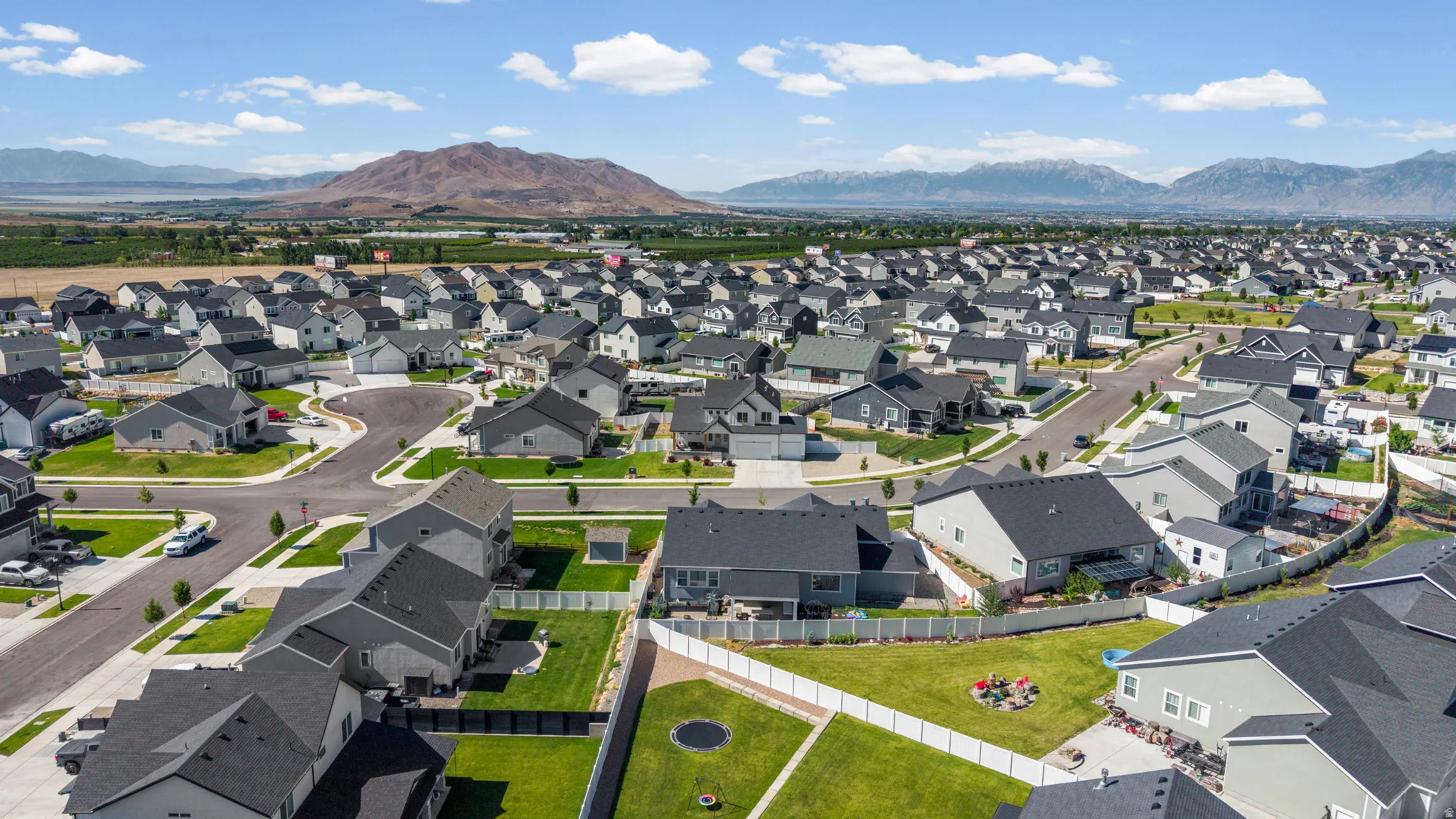 Aerial perspective of a developed residential community with diverse single-family homes