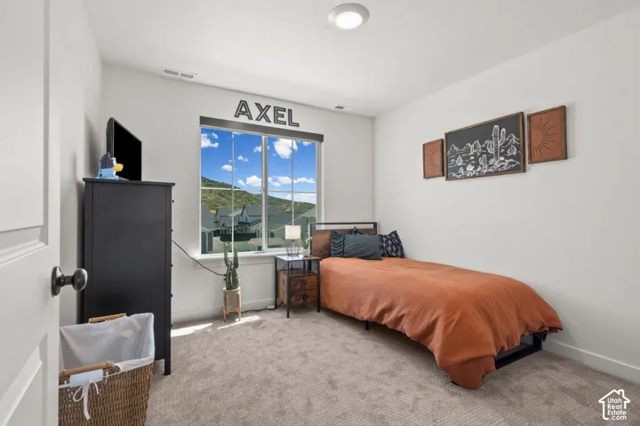 Carpeted room with a large window