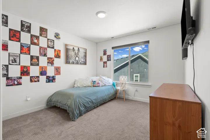 Carpeted room with a large window and a ceiling-mounted light fixture