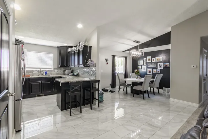 Open-concept kitchen and dining area featuring ceramic tile flooring