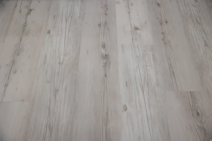 Light wood-finish flooring with visible grain and knot details