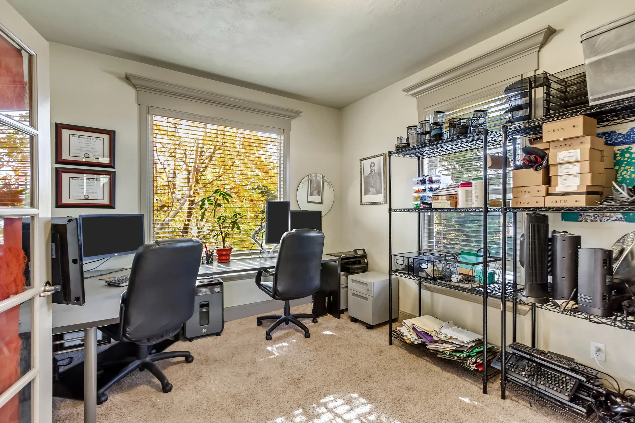 Carpeted room featuring a large window with horizontal blinds, providing ample natural light