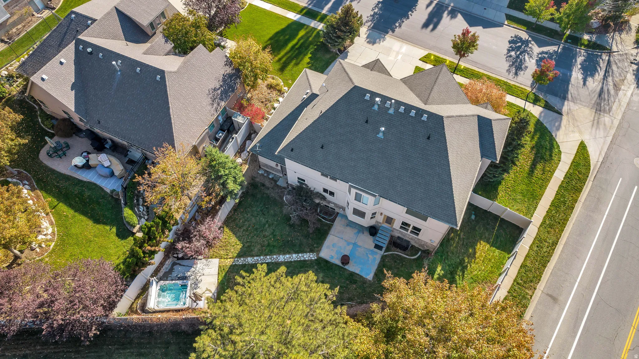 Aerial perspective showcasing a property with a multi-gabled roofline and extensive landscaping