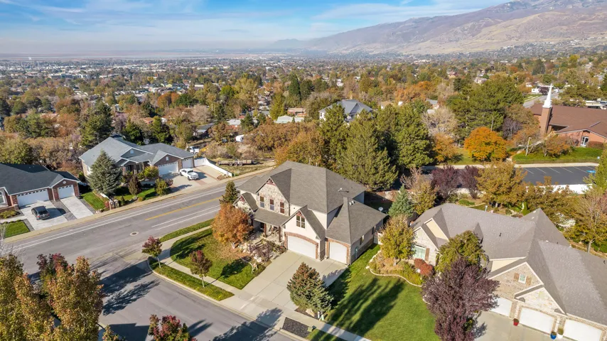 Expansive aerial perspective showcasing a residential neighborhood with a distant mountain range backdrop