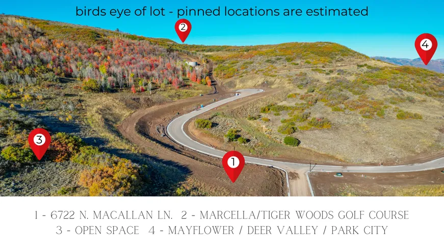 Expansive hillside lot featuring a paved road, natural terrain, and distant mountain ranges