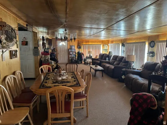 Open concept living area with wood paneling and a dining space