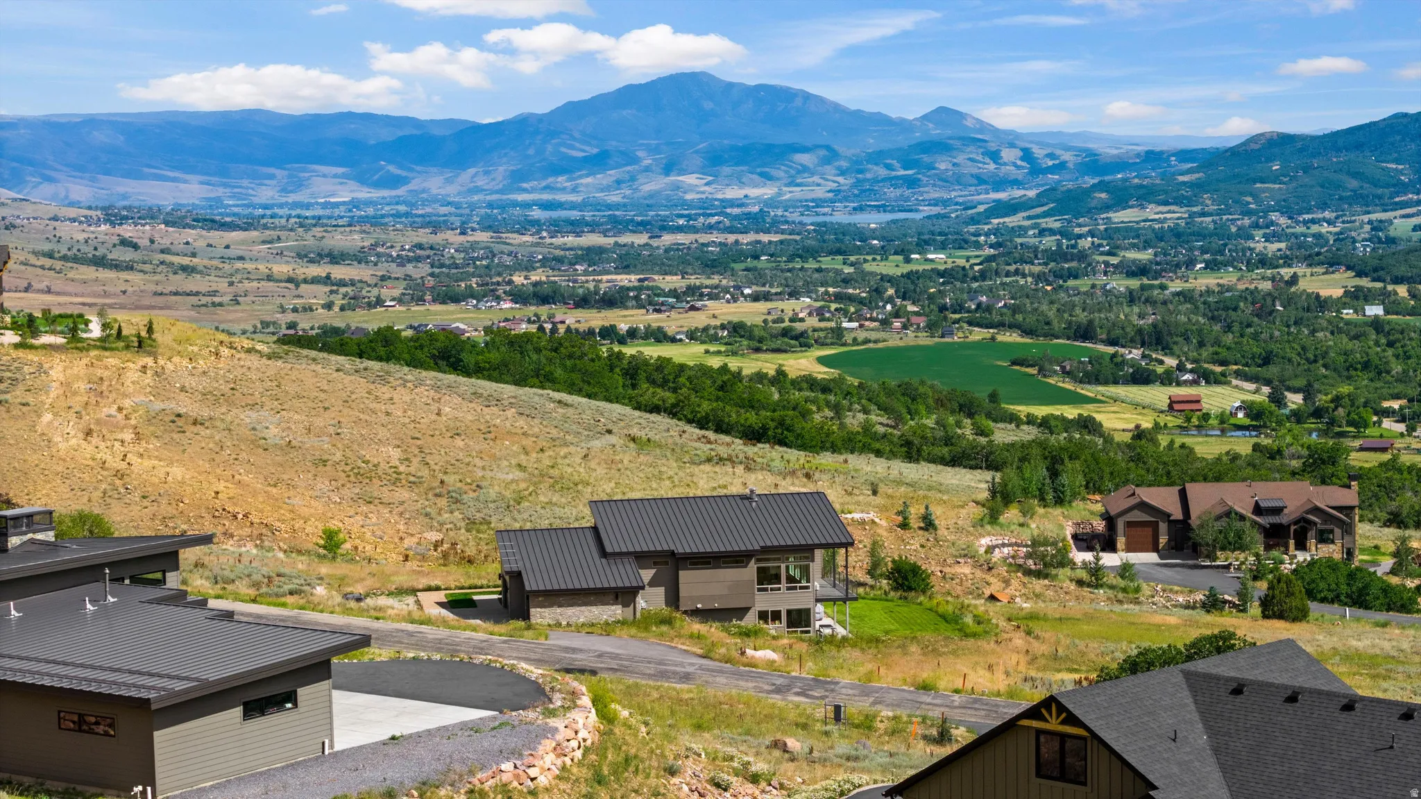 Expansive mountain landscape with distant valley and cultivated fields