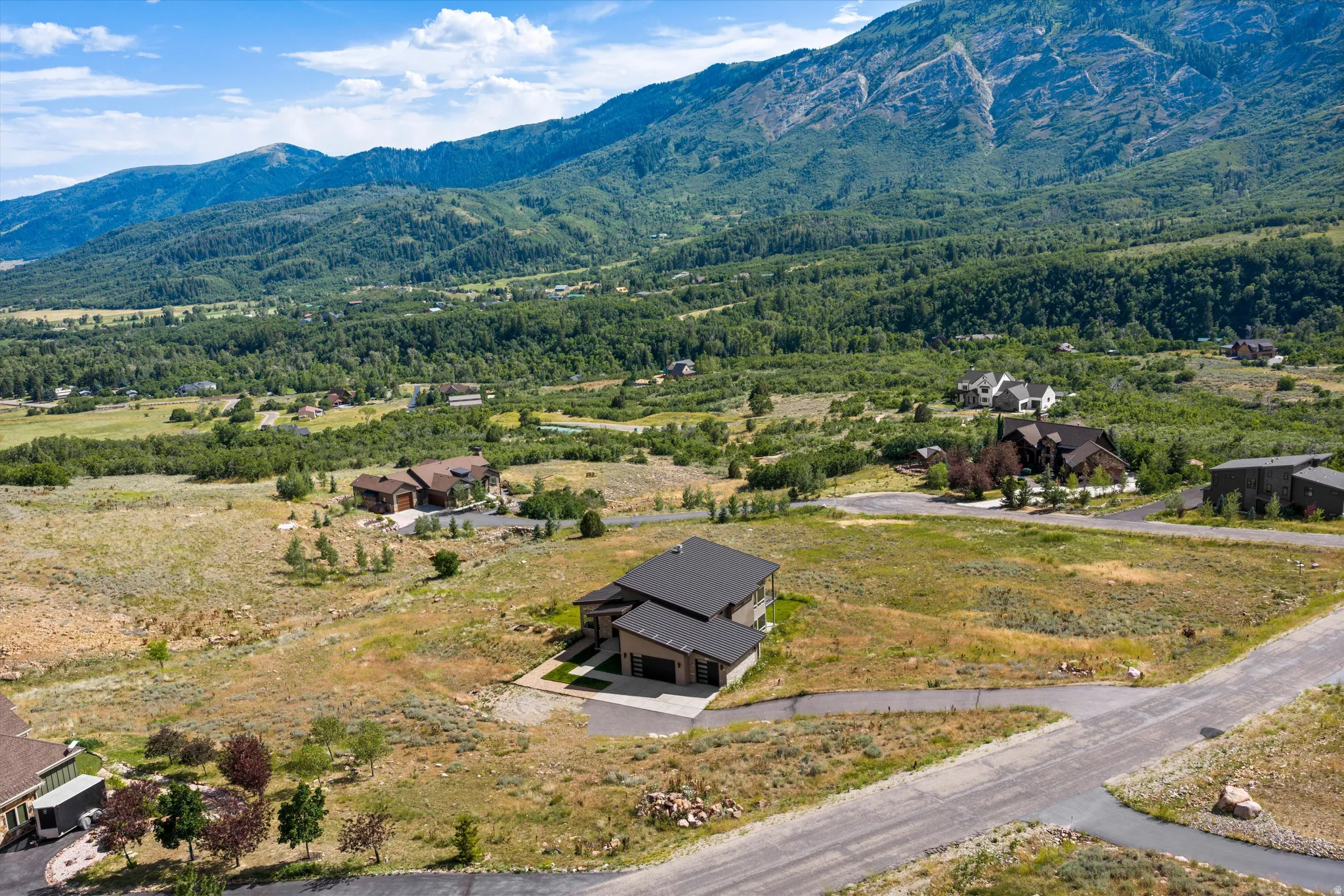 Contemporary mountain residence featuring a multi-level design and an attached three-car garage