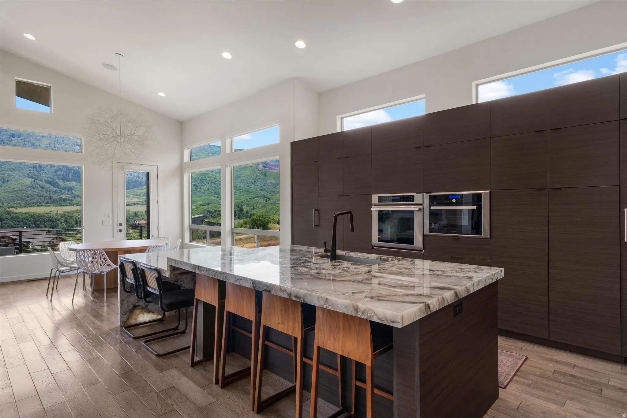 Contemporary kitchen featuring a large island with a substantial stone countertop