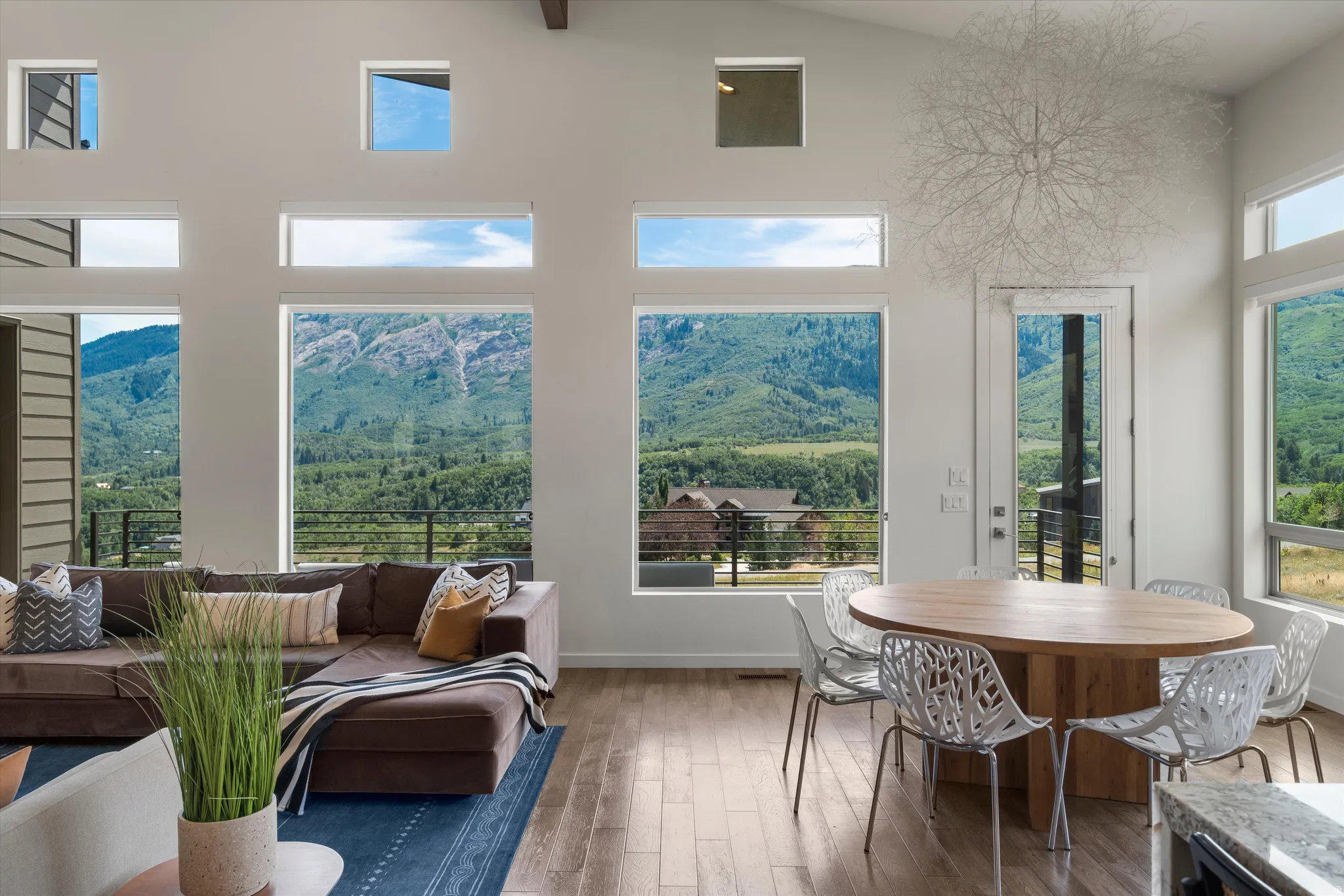 Open-concept living area with vaulted ceilings and exposed wood beams