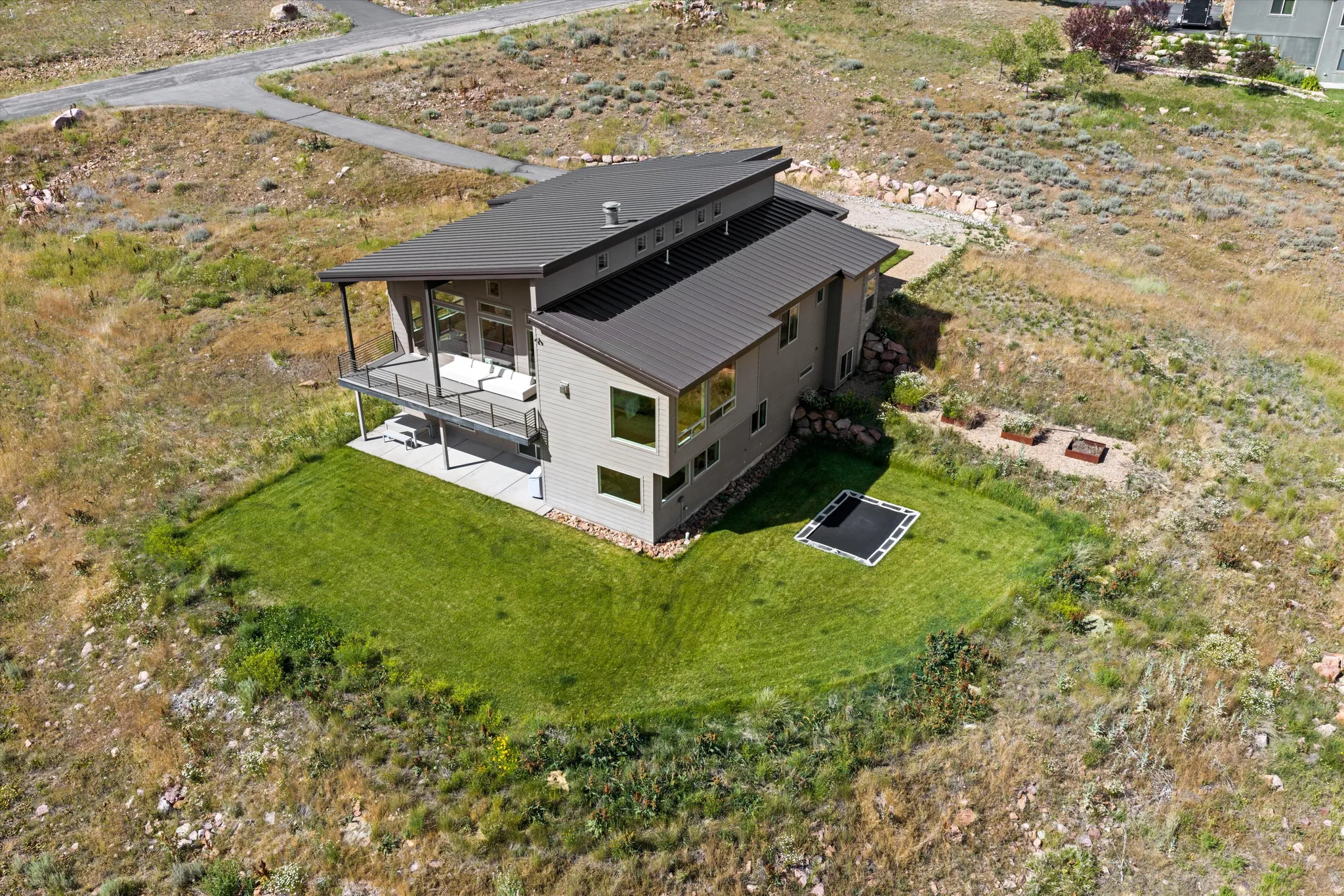 Modern architectural design featuring a multi-level structure with a dark metal roof