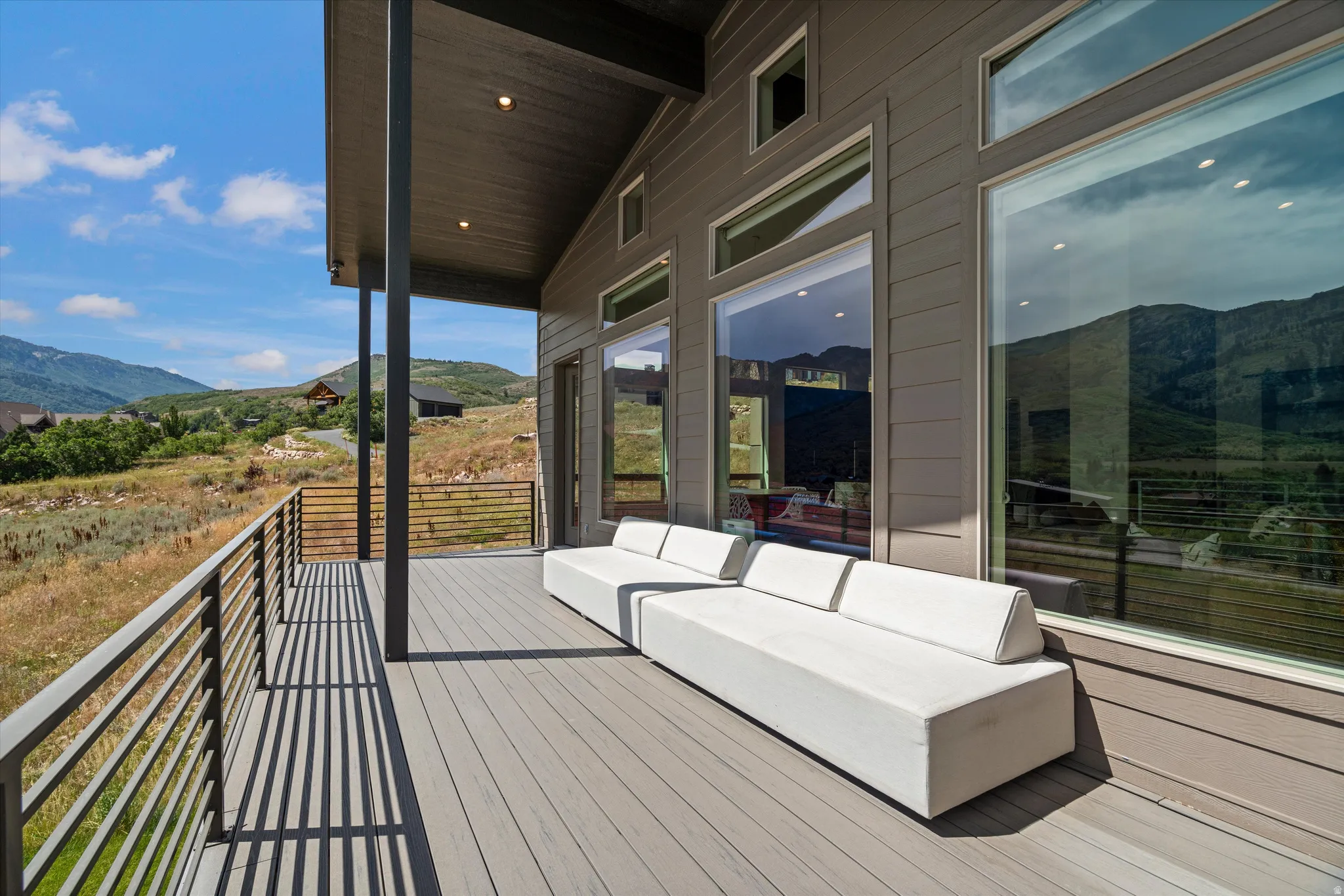 Expansive outdoor deck featuring composite decking and modern metal railings