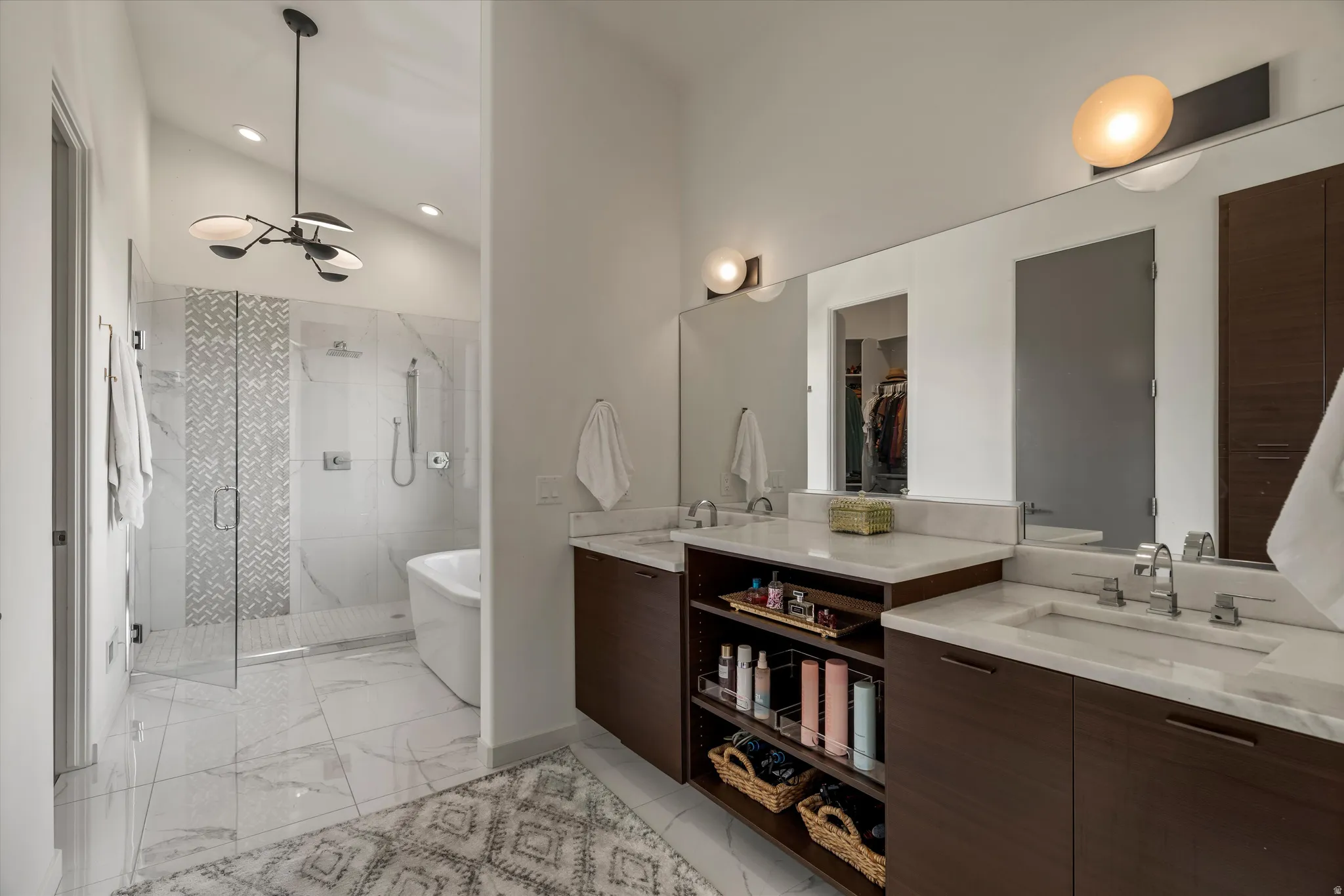 Dual vanity featuring wood-finish cabinetry, white countertops, and undermount sinks